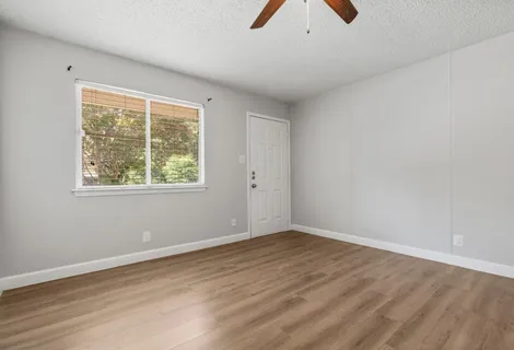 wooden floor in an empty room with a window