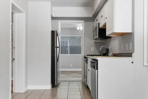 a kitchen with a refrigerator stove and microwave
