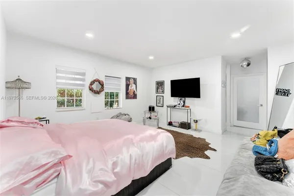 a bedroom with a bed and a flat screen tv