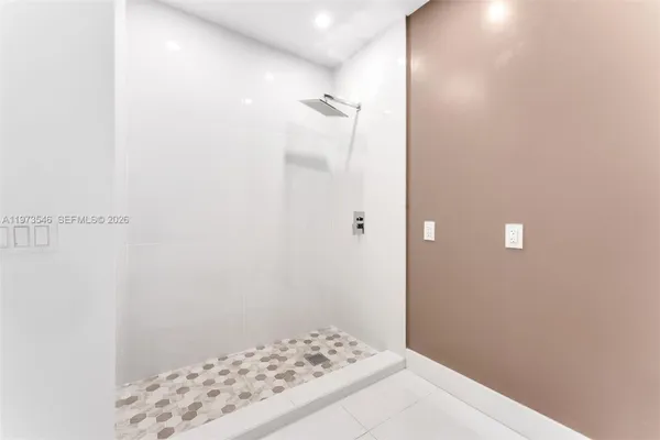 a bathroom with a sink double vanity granite tub shower and a mirror