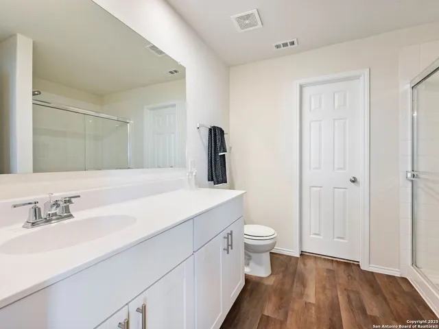 a bathroom with a glass shower door