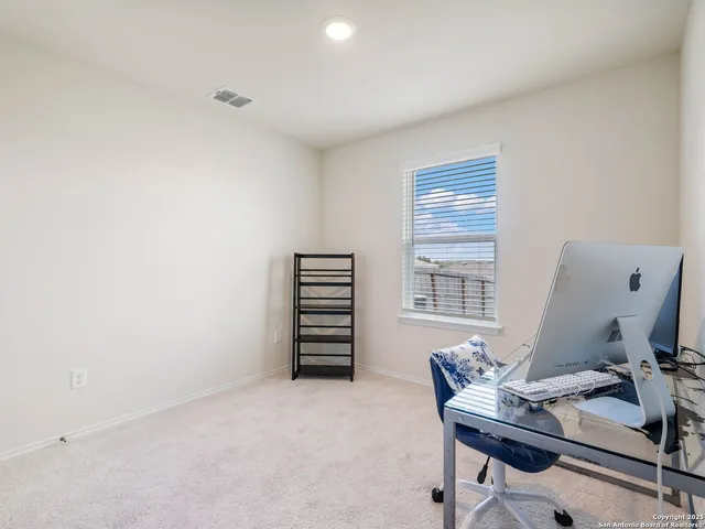 a bathroom with a sink a toilet and shower curtain