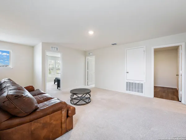 a living room with furniture a couch and a window