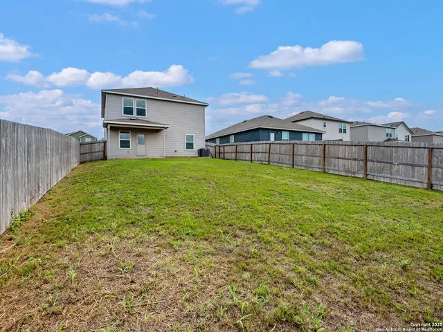 a view of a house with a yard and sitting area