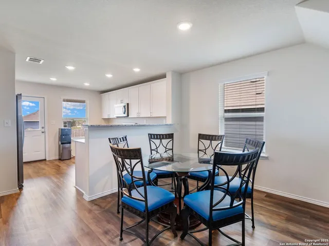 a kitchen with granite countertop a sink dishwasher a stove and a refrigerator