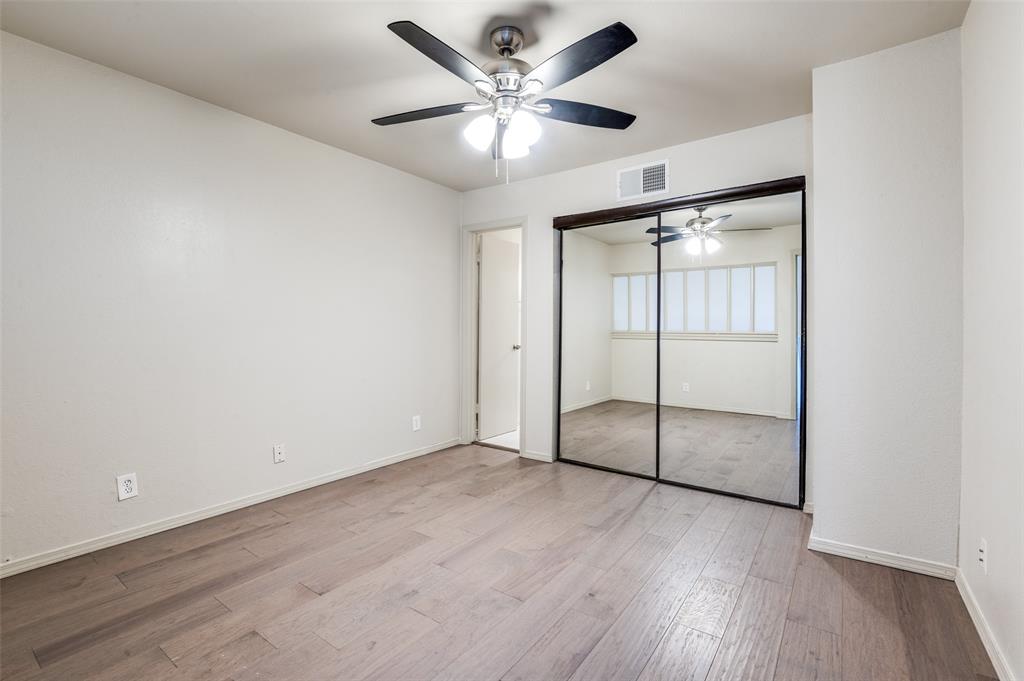18240 Midway Road, Unit 1704 Dallas, TX 75287 - Photo 15 of 25 an empty room with wooden floor and fan