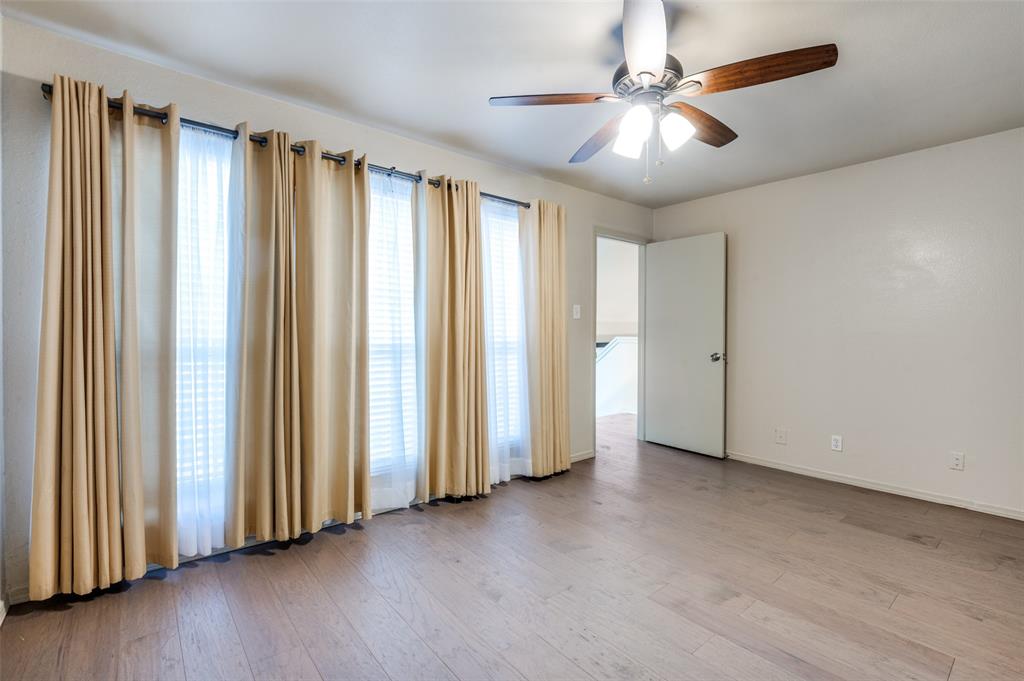 18240 Midway Road, Unit 1704 Dallas, TX 75287 - Photo 16 of 25 an empty room with windows and ceiling fan