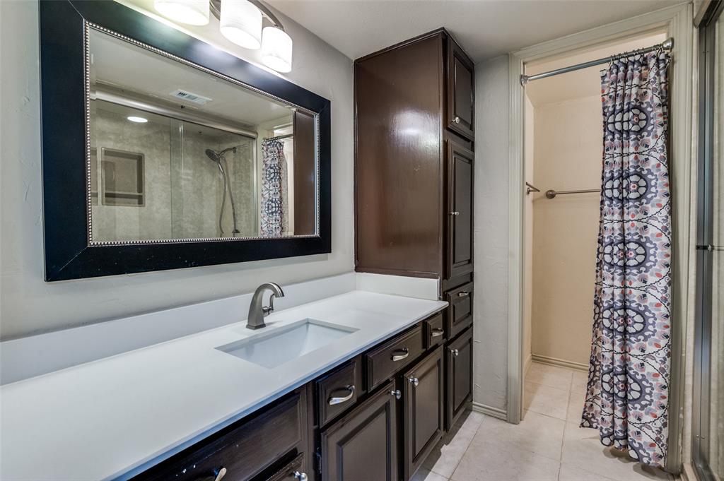 18240 Midway Road, Unit 1704 Dallas, TX 75287 - Photo 22 of 25 a bathroom with a sink a light fixture and a mirror
