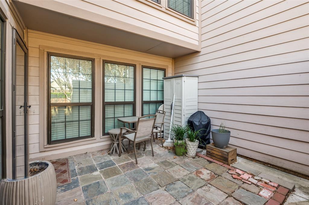 18240 Midway Road, Unit 1704 Dallas, TX 75287 - Photo 24 of 25 a view of a patio with table and chairs and wooden floor