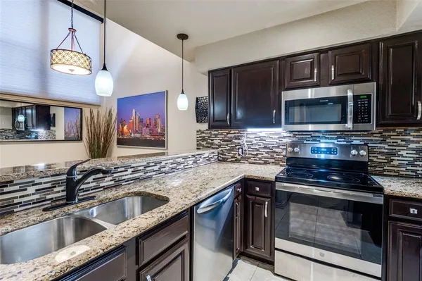a kitchen with cabinets appliances and a counter top