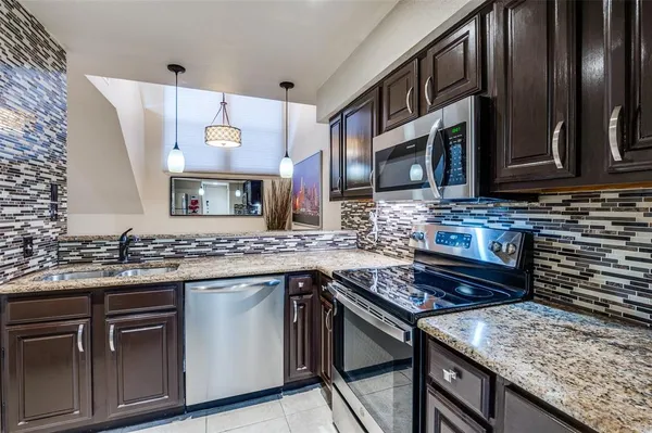 a kitchen with a stove and a sink