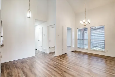 a view of a room with wooden floor and window