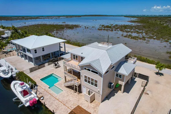 an aerial view of a house with a ocean view