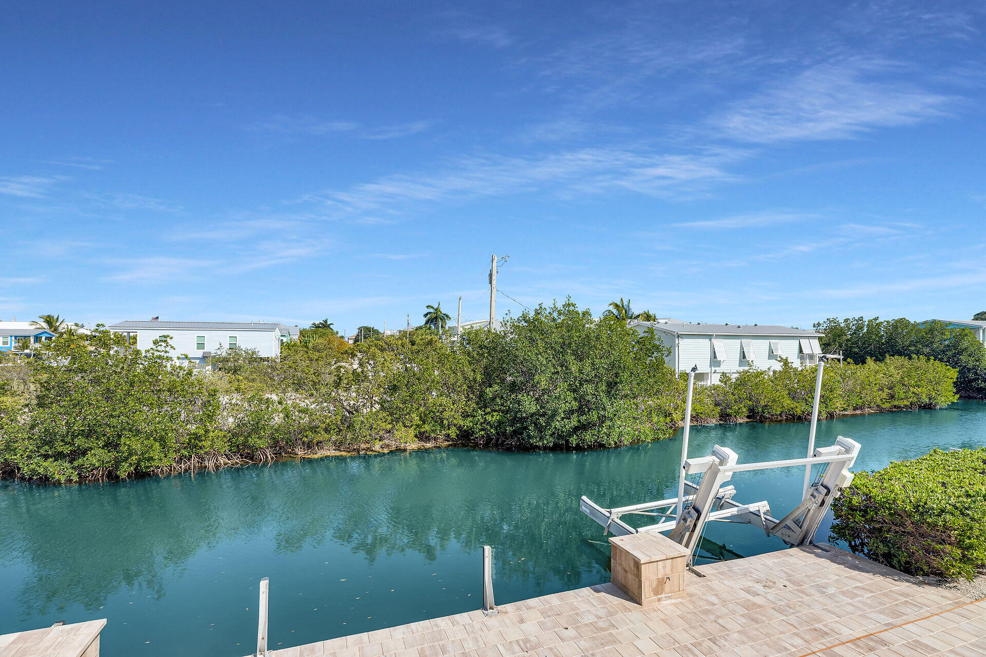333 Indies Road Summerland Key, FL 33042 - Photo 12 of 66 a view of a lake with a house in the background