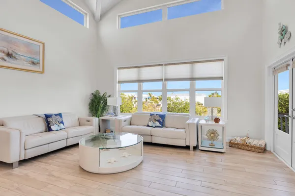 a kitchen with a sink stove and white cabinets with wooden floor