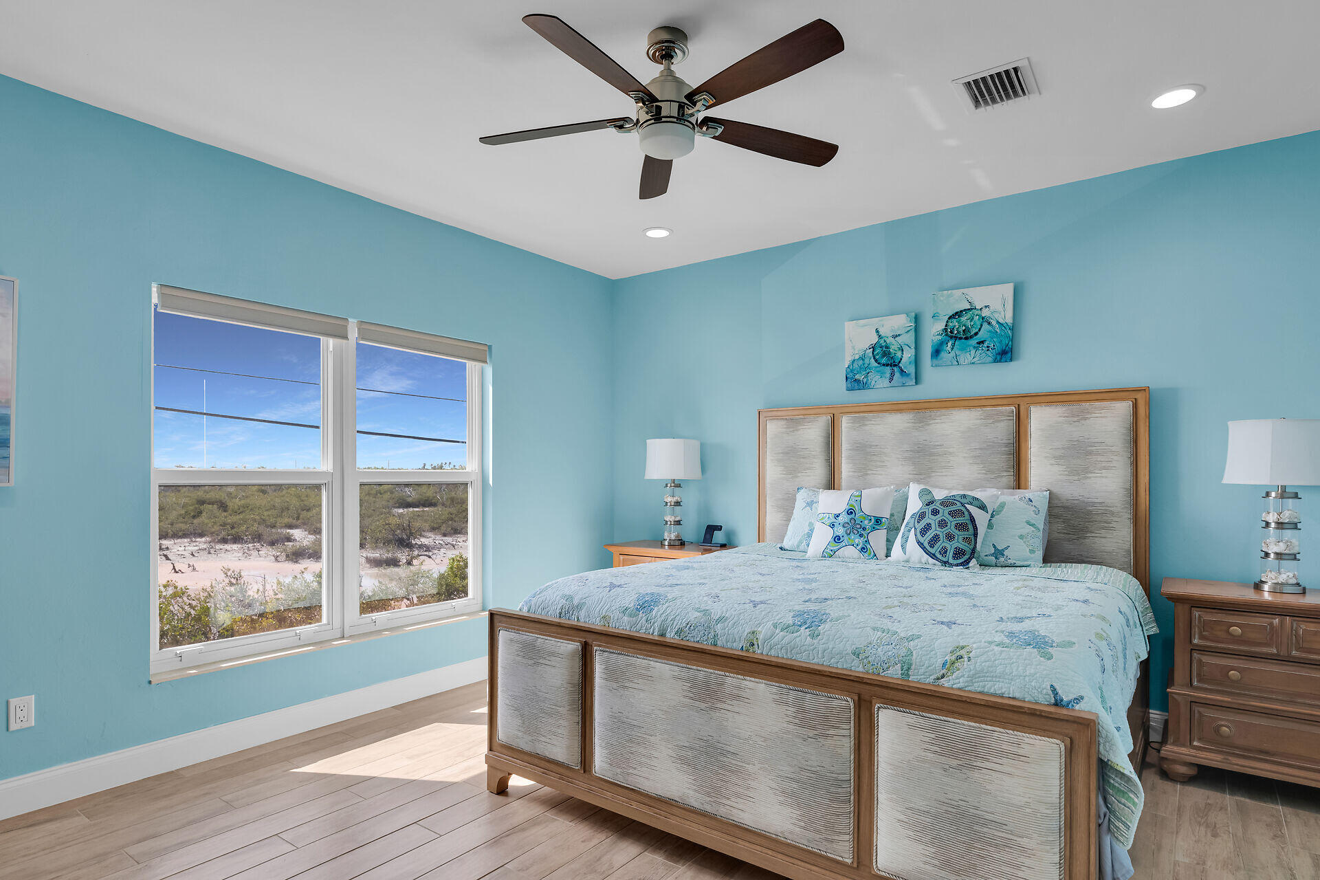 333 Indies Road Summerland Key, FL 33042 - Photo 30 of 66 a bedroom with a large bed and a chandelier