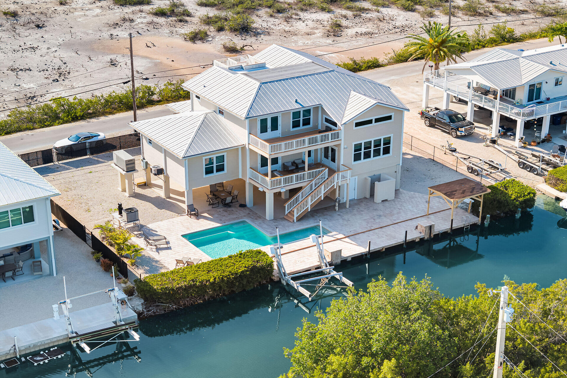 333 Indies Road Summerland Key, FL 33042 - Photo 49 of 66 an aerial view of a house with a big yard and a large pool