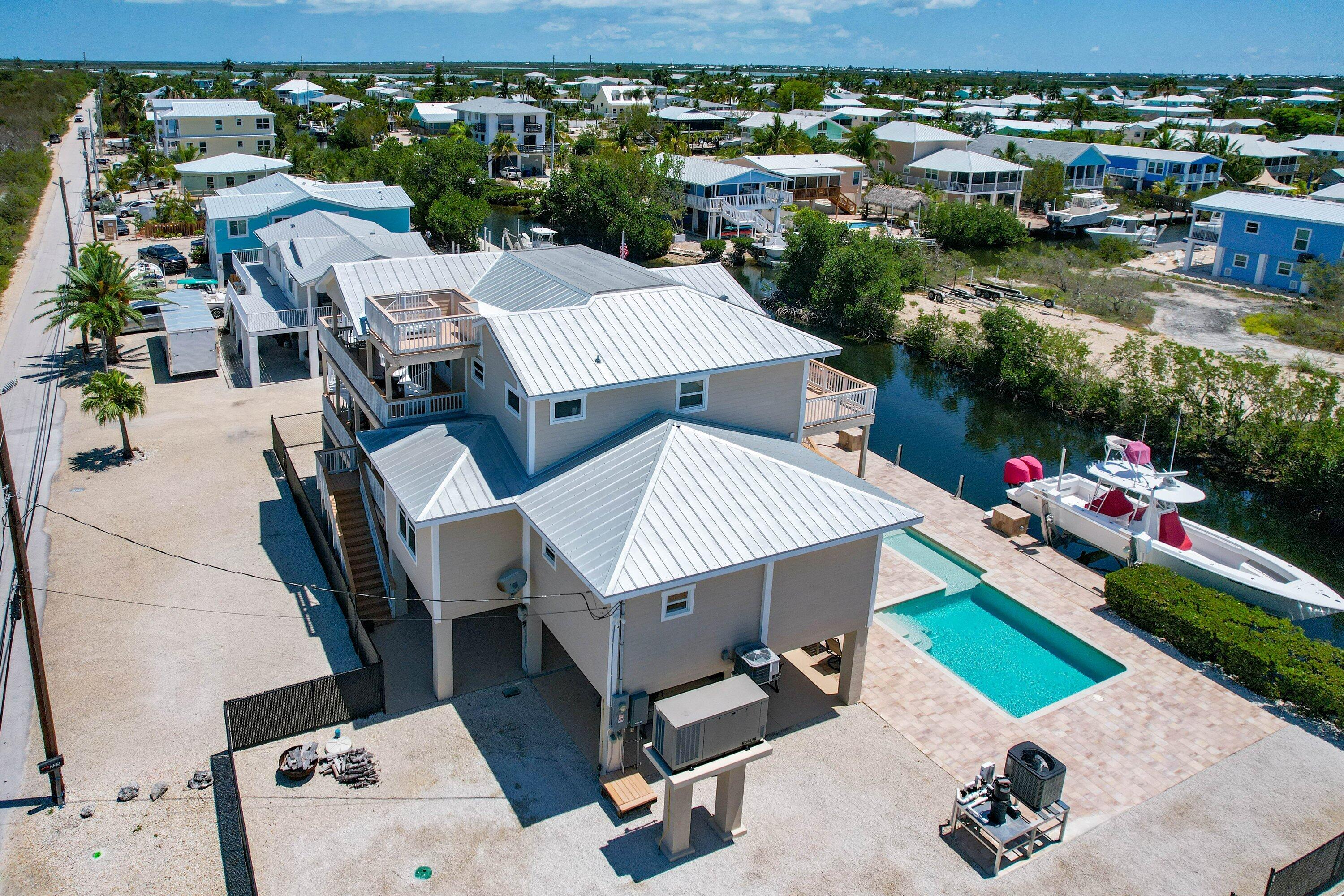 333 Indies Road Summerland Key, FL 33042 - Photo 64 of 66 an aerial view of a house with a yard and lake view