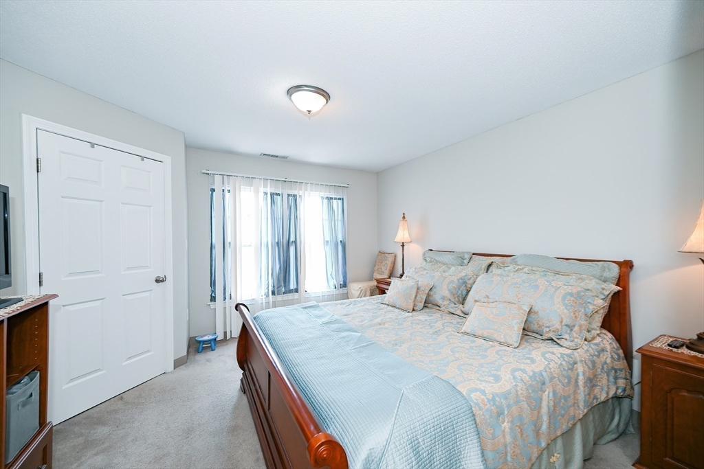 84 Mill Street, Unit 304 Woonsocket, RI 02895 - Photo 13 of 25 a bedroom with a bed and a window