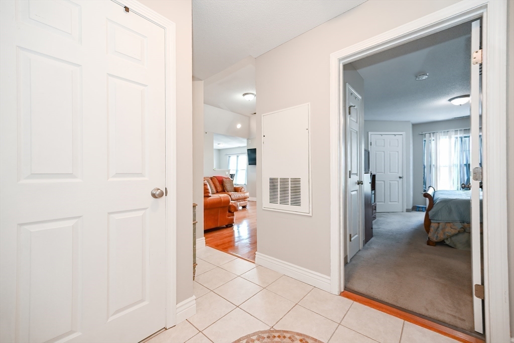 84 Mill Street, Unit 304 Woonsocket, RI 02895 - Photo 18 of 25 a view of a hallway with a livingroom and a bathroom with a sink