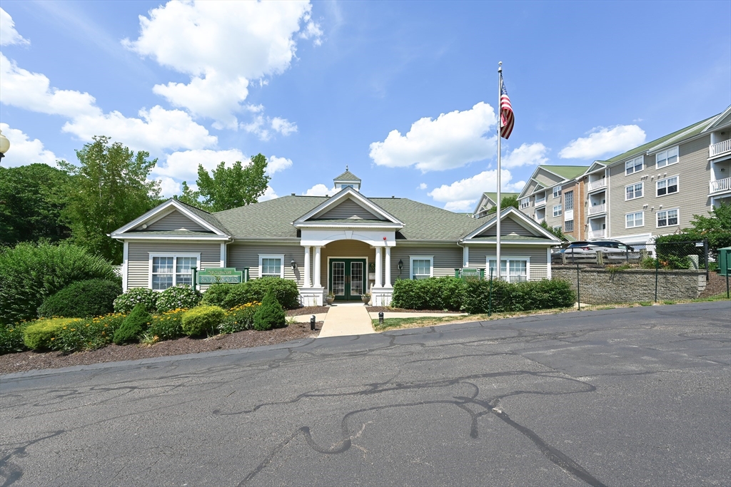 84 Mill Street, Unit 304 Woonsocket, RI 02895 - Photo 25 of 25 a front view of a house with a yard and potted plants
