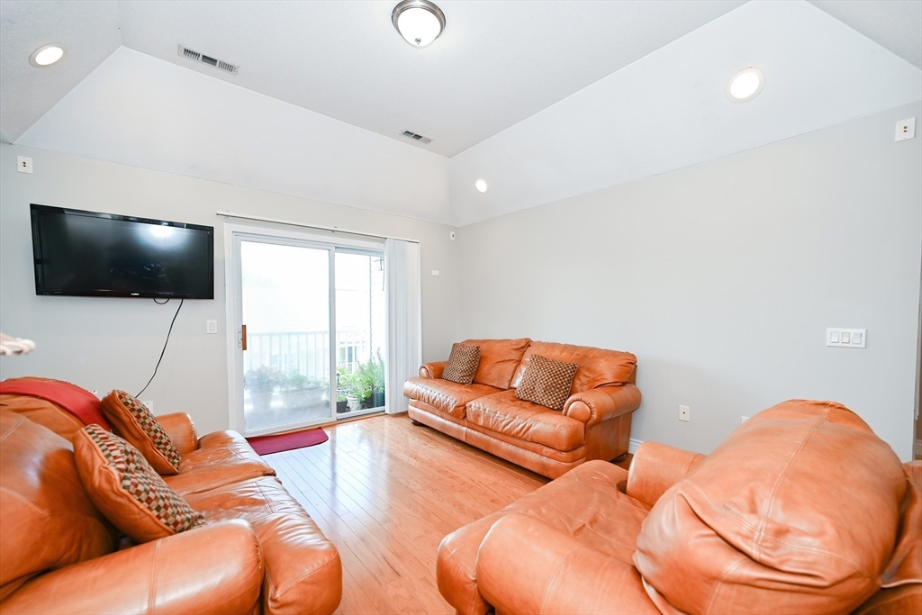 84 Mill Street, Unit 304 Woonsocket, RI 02895 - Photo 3 of 25 a living room with furniture and a flat screen tv