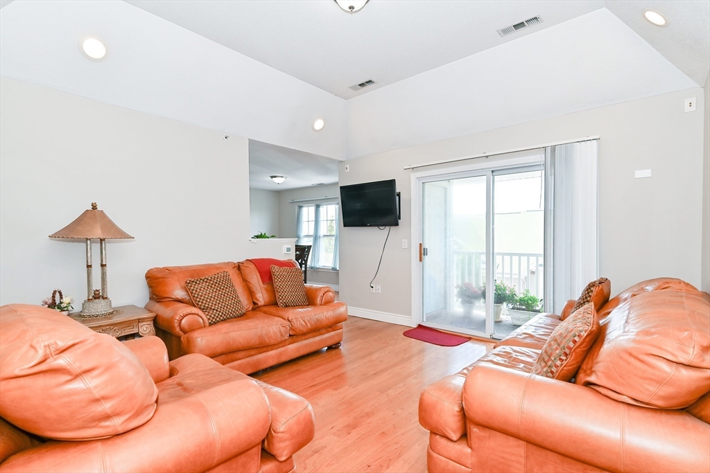 84 Mill Street, Unit 304 Woonsocket, RI 02895 - Photo 4 of 25 a living room with furniture and a flat screen tv