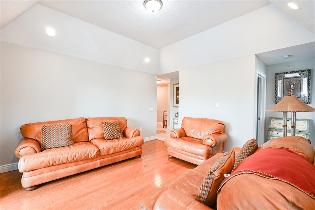 84 Mill Street, Unit 304 Woonsocket, RI 02895 - Photo 5 of 25 a living room with furniture and a couch