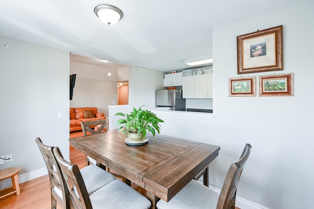 84 Mill Street, Unit 304 Woonsocket, RI 02895 - Photo 8 of 25 a living room with furniture and wooden floor