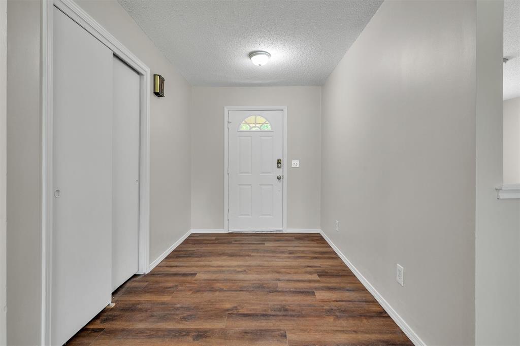209 Mistletoe Lane Keene, TX 76059 - Photo 11 of 38 a view of a hallway with wooden floor