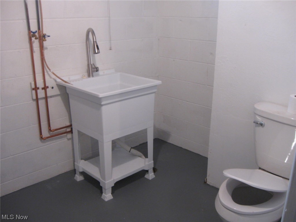 8205 Springview Road Northfield, OH 44067 - Photo 16 of 20 Bathroom featuring toilet, concrete flooring, and vanity