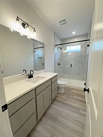 a bathroom with a double vanity sink a mirror and shower