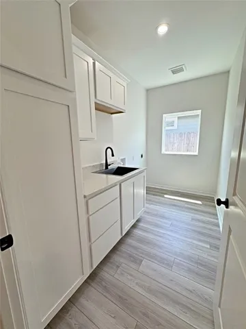 a kitchen with a sink and cabinets