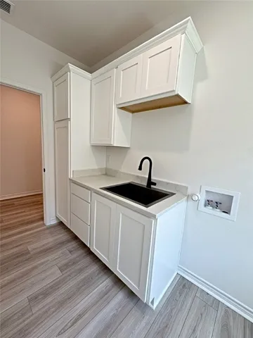 a kitchen with stainless steel appliances granite countertop a sink a stove and wooden floor