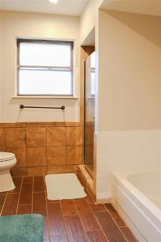 a bathroom with a toilet and a shower