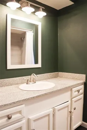 a bathroom with a sink vanity and a mirror