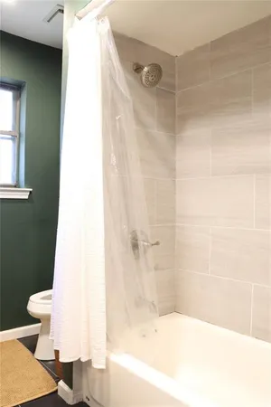 a bathroom with a bathtub and a toilet
