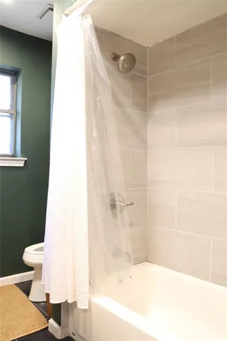 a bathroom with a bathtub and a toilet