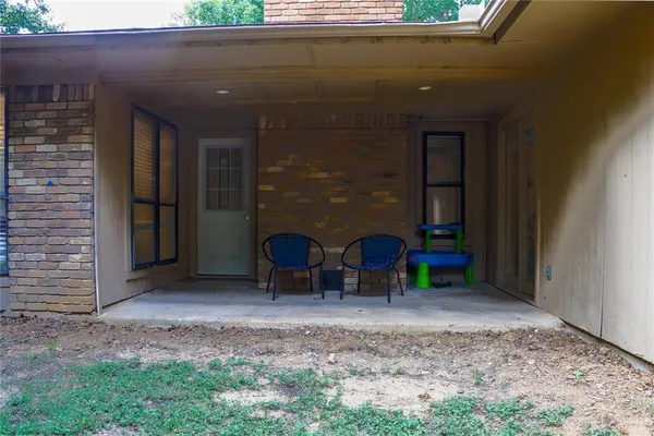 a view of a two chairs in front of a door
