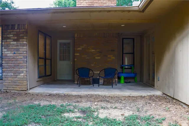 a view of a two chairs in front of a door