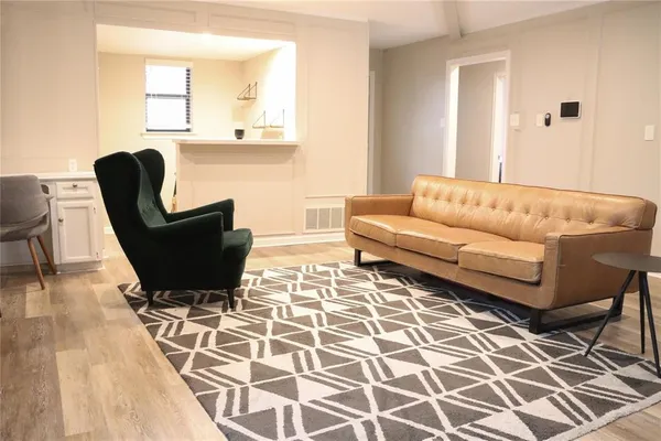 a living room with a couch and a rug