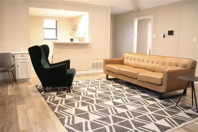 a living room with a couch and a rug