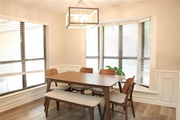 a view of a dining room with furniture and wooden floor
