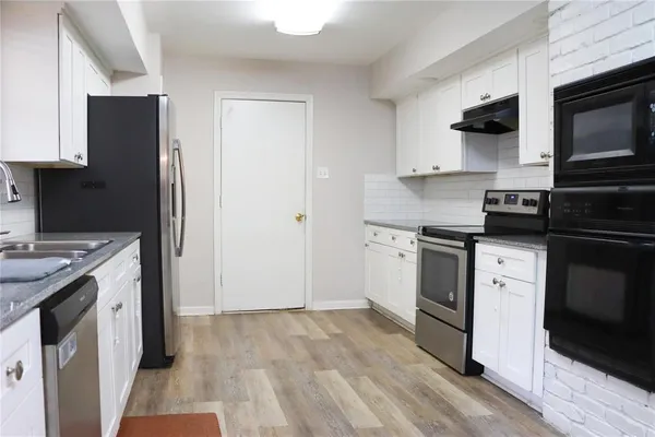a kitchen with a sink stove and microwave