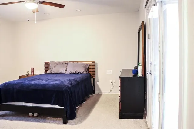 a bedroom with a bed and a mirror