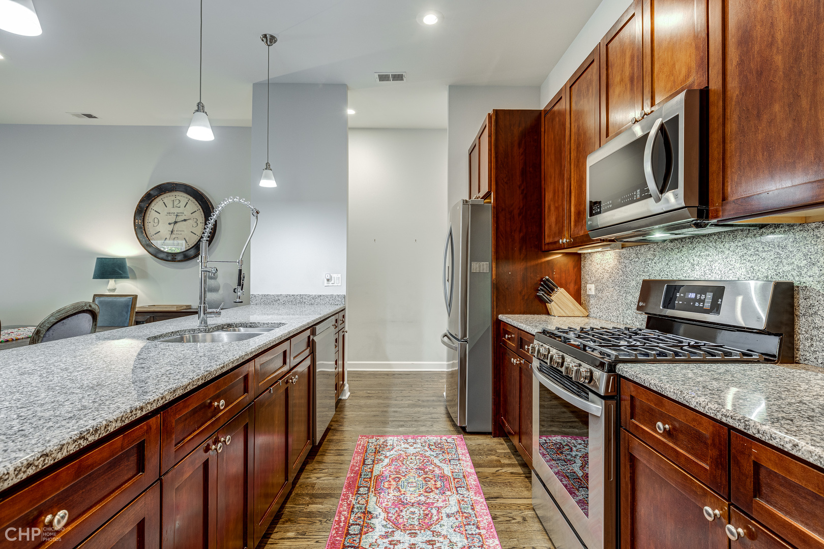 4603 North Racine Avenue, Unit 201 Chicago, IL 60640 - Photo 11 of 33 a kitchen with stainless steel appliances granite countertop a stove a sink and a microwave