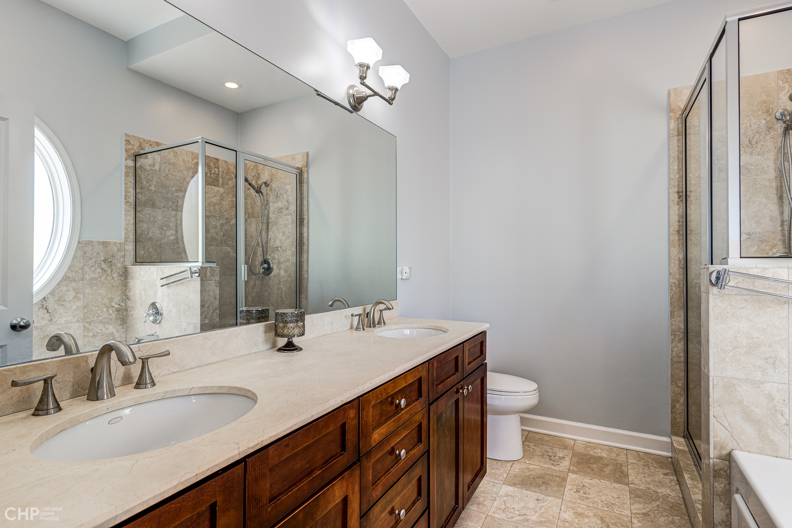 4603 North Racine Avenue, Unit 201 Chicago, IL 60640 - Photo 17 of 33 a bathroom with a double vanity sink mirror and toilet