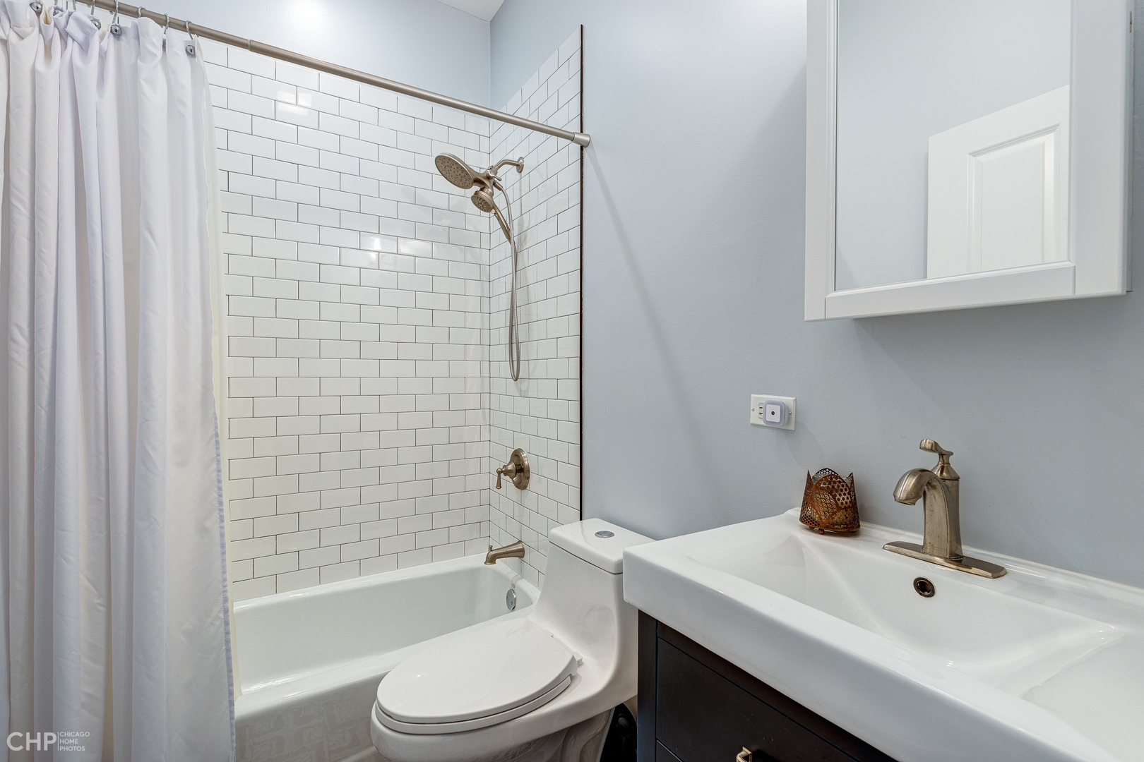 4603 North Racine Avenue, Unit 201 Chicago, IL 60640 - Photo 22 of 33 a bathroom with a sink toilet and shower