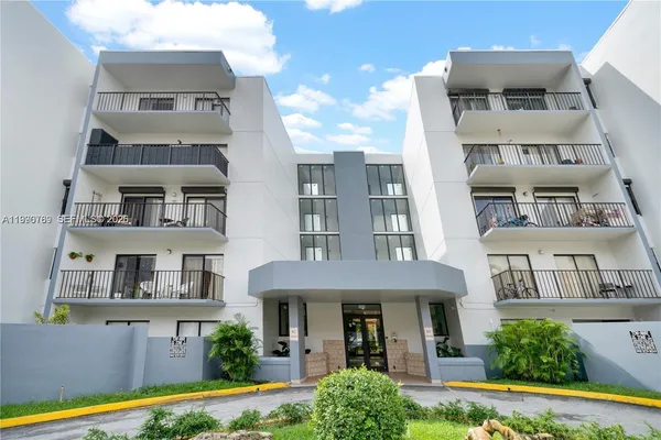 a front view of a residential apartment building with a yard