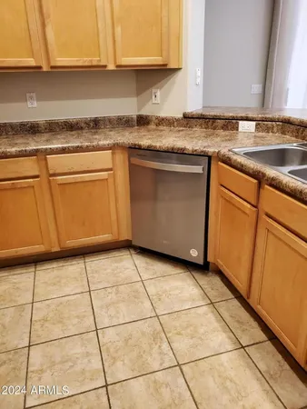 a bathroom with a granite countertop toilet sink and mirror